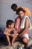 A father and his son on the Ganges river bank.