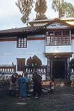 Pounding barley to dehusk the grain in front of Jangsa Gompa, also known as the Bhutanese Monastery in Kalimpong.