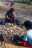 Snappy Arawatau and his wife wife Marlyna getting copra from coconut shells, Tuarubu.