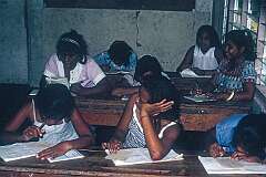 Girls writing lessons in class.