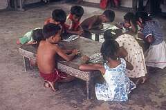 Young children writing on slates in St Jihn Primary School on Abaiang atoll.