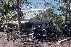 A house and wrecked truck in Tabwewa (Tabewa).