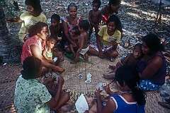 Women playing cards in the village of Ukiangang.