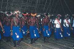 Singing and dancing with costume designs representing Halley's Comet, in the Maneaba “Te Nanoraoi” in Kuma.