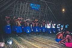 Singing and dancing with costume designs representing Halley's Comet, in the Maneaba “Te Nanoraoi”, Kuma village.
