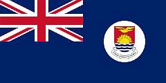 GILBERT ISLANDS, 1976 - In 1971, the Gilbert and Ellice Islands became autonomous, and in 1975, the Ellice Islands were separated, becoming the independent state of Tuvalu in 1978. The flag was adopted, now featuring, on a white disk, the arms of the Gilbert Islands, with, on the ribbon under the shield, the Gilbertese motto “Te Mauri te Raoi ao te Tabomoa” (Health, Peace, and Prosperity).