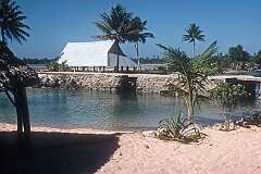 The maneaba, meeting house, made from sheet metal, at the lagoon in Makin village.