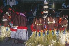 Dancers in traditional dress praying at the wedding cake, during the wedding reception.