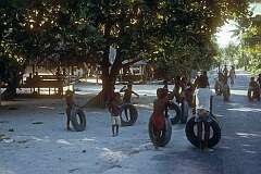 Children playing with tyres, Betio.