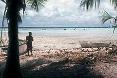 The lagoon of Tabiteuea islet, with men racing model canoes.