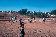 Nama boys playing football, with the ”location“ of Gibeon in the background.