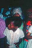 A young boy dancing in the mission building of Gibeon Roman Catholic Church.