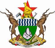 REPUBLIC OF ZIMBABWE, 1981 - On 21 September 1981, a new coat of arms of Zimbabwe was adopted, replacing the one of Rhodesia. It features a green shield with blue and white wavy lines, symbolising the fertility of the country’s soil and prosperity-bringing water, accompanied by a representation of Great Zimbabwe, representing the country’s historical heritage. It is supported by two kudus, standing on an earthen mount with stalks of wheat, a cotton boll and a head of maise. Behind the shield is an agricultural hoe and an A.K. automatic rifle, symbolising the transition from war to peace. A star, a symbol of hope for the future, coloured red as a reminder of past suffering, with the Great Zimbabwe Bird, the distinctive national emblem, surmounts it. The motto “Unity Freedom Work” is on a scroll at the bottom.