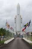 Kourou, French Guiana - An Ariane rocket and flags of the participating countries in the European Space Agency, at the entrance to the Centre Spatial Guyanais.