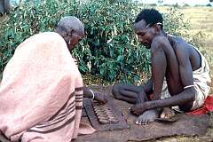 Maralal, Kenya, 1973 - Samburu men play 'warri', a game known throughout Africa.